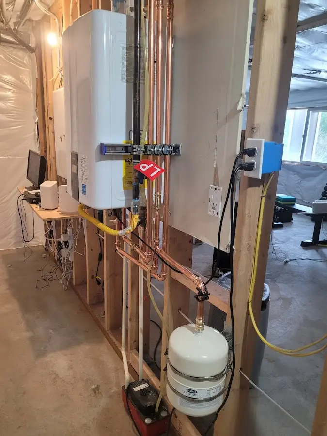 Licensed plumber repairing a kitchen sink in Newport